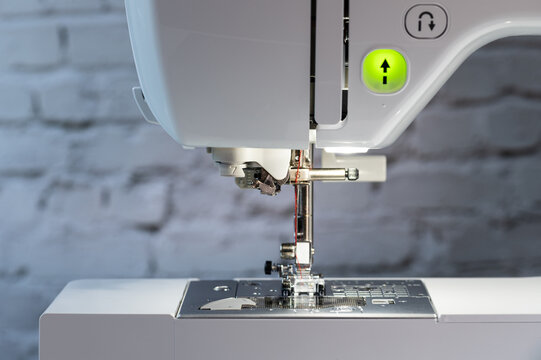 Sewing machine with green light-up switch button