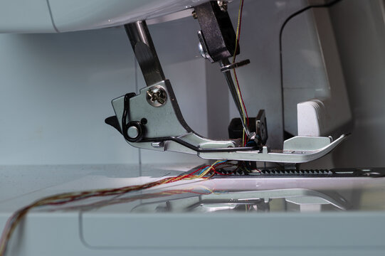 Overlock sewing machine foot with two needles at the top and carrier with view from the left side