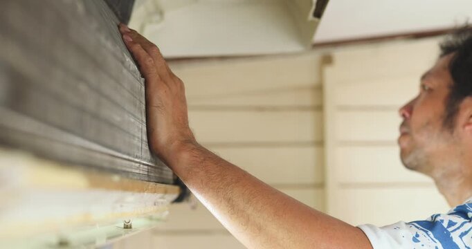 Mechanic man repair and clean air condition in city home diagnostic electronic industry