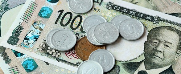 Japanese yen money bills and coins on table. Japan cash of JPY currency close up © Larysa