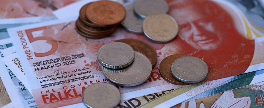 Falkland Islands pound money bills and coins on table. Falkland Islands cash of FKP currency