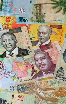 Bahamian dollar money banknotes bunch on table. Bahamas bills of BSD currency close up