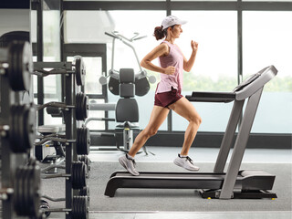 Fototapeta premium Woman running on a treadmill