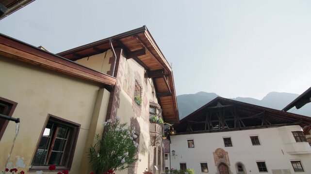 Architecture of houses in the alpine village of Umhausen in the Oetz Valley Austria. Beautiful historic mountain houses, urban urban landscapes, travel and tourism in Tyrol, Europe.