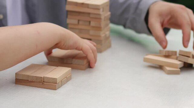 Wooden blocks. Board game. Teenager's hands. Father and son. Slow motion video. . High quality 4k footage