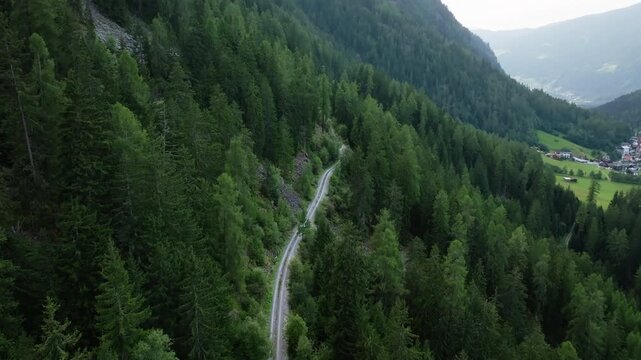 Beautiful aerial landscape of winding alpine highways in Tyrol Austria passing through pine forests mountain ridges and pristine nature for tourism