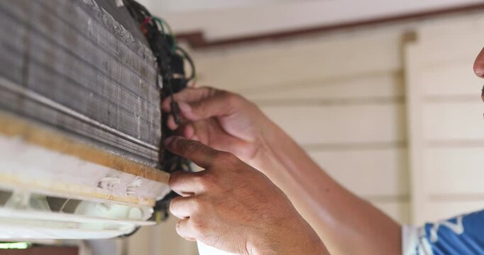 Mechanic man repair and clean air condition in city home diagnostic electronic industry