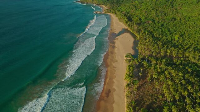 High Altitude Aerial Backwards Reveal of Duli Beach in El Nido, Philippines. Cinematic Drone Pull Away View of Golden Sand Shoreline, Rolling Ocean Surf, and Vast Deep Sea.