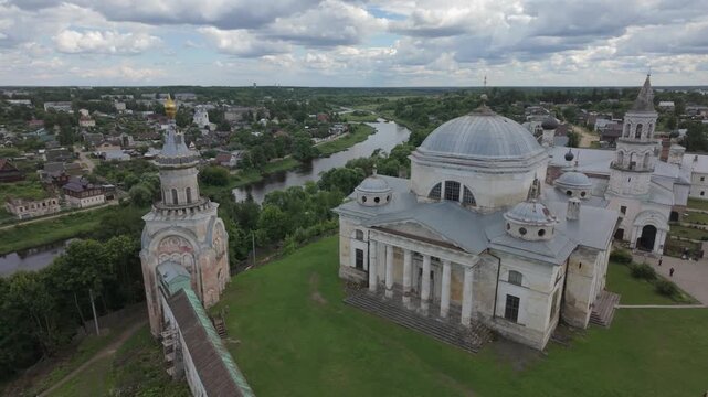 Historic cathedral complex with bell tower and river landscape from aerial view