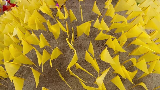 Yellow paper triangle flags on sand pagoda during Songkran festival