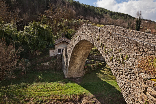 Portico di Romagna, Forli Cesena, Emilia Romagna, Italy: ancient humpback bridge over the Montone River and the Oratorio della Visitazione, small historic church in the medieval village.
