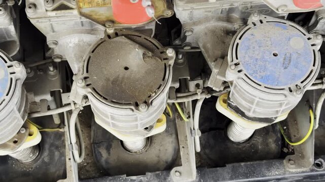 Industrial machine shows circular covers above spring mounted units. Dusty components hold aligned positions supporting constant mechanical work