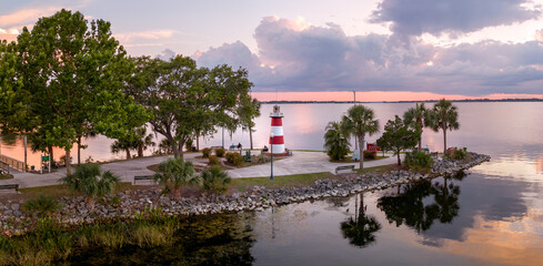 Mount Dora Lighthouse on Lake Dora at sunset with dramatic clouds. Florida, USA. May 18, 2023.  © JHorsey