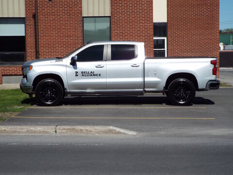 Gatineau,Quebec, Canada &ndash; May 17, 2026:A silver "Bellai Alliance pickup truck" is parked beside a brick building, une camionnette argent&eacute;e stationn&eacute;e dehors on Rue Jean-Proulx. 