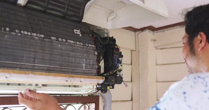 Mechanic man repair and clean air condition in city home diagnostic electronic industry