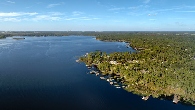 Aerial Drone View of Lake Mary Jane in the Lake Nona, Orlando area featuring waterfront homes, private docks, and lush green forest, USA.  October 25, 2025. 