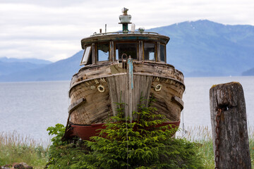 Rustic Abandoned Wooden Boat on the Scenic Shoreline of Hoonah, Alaska. Summer 2025. © JHorsey
