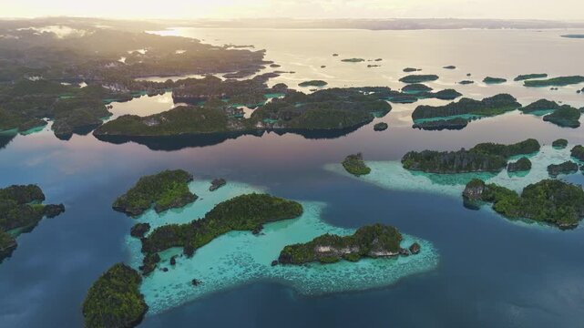 Breathtaking aerial flyover above exotic Misool limestone island beaches &ndash; Spectacular cinematic drone shot of untouched tropical paradise in Papua Indonesia, premium travel background asset