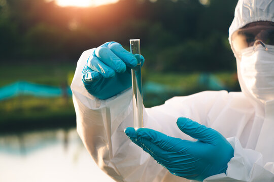 Environmental scientist conducting water sample collection to evaluate ecosystem health and water safety.
