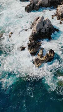 Aerial shot of Mediterranean coastline with dramatic wave impact. Abstract nature visual for backgrounds