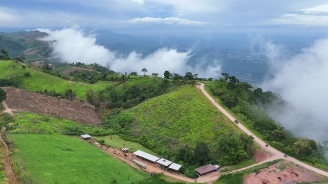 An aerial video showing stunning mountain views in Thailand, featuring a paved road and morning mist.