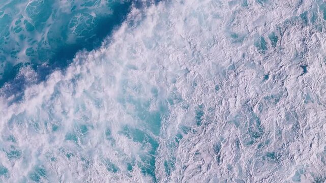 Top view of foamy ocean surface with powerful waves rolling across the Atlantic Ocean
