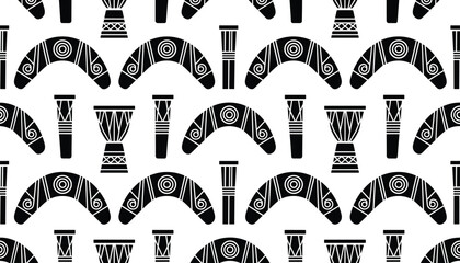 Fototapeta premium Seamless pattern of traditional tribal items like boomerangs and drums in a monochrome black and white minimalist graphic style.