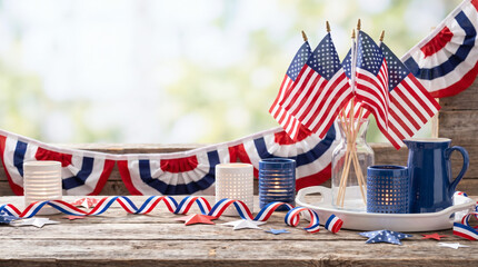 Obraz premium Patriotic 4th of July decoration setup on a wooden table outdoors with flags and ribbons