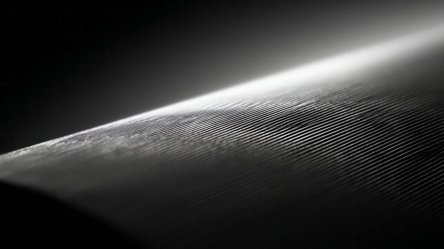 Close up of finely textured surface with diagonal lines catching light.