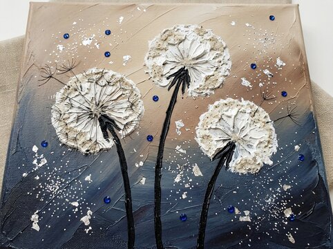 Three white dandelion flowers on dark blue background with blue beads