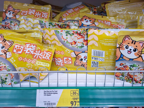 VORONEZH, Russia - April 05, 2026.Hua Qing Jun instant rice packs with chicken flavor on grocery shelf in Russia featuring cat design