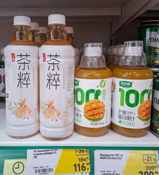 VORONEZH, Russia - April 05, 2026.Plastic bottles of JML jasmine tea and Woerwang mango juice on shelf in supermarket in Russia