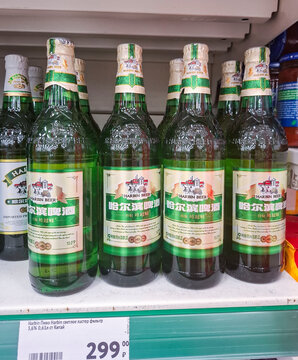VORONEZH, Russia - April 05, 2026.Imported bottles of Harbin lager beer on a grocery store shelf in Russia with visible price tags and labels