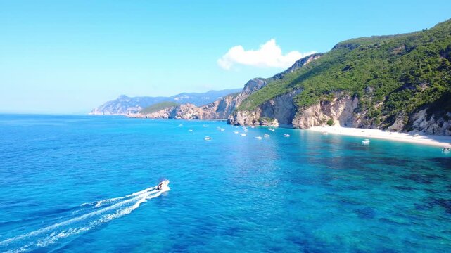 A boat sailing near a beach in Corfu Greece. A boat is sailing near the beach. Corfu Greece beach