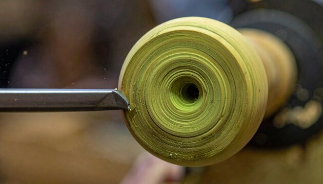 Close up of a green metal gear wheel mechanism.