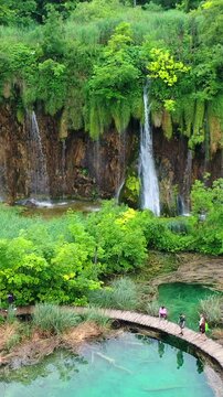 Beautiful waterfalls flowing through the lush landscape of Plitvice Lakes National Park, Croatia.