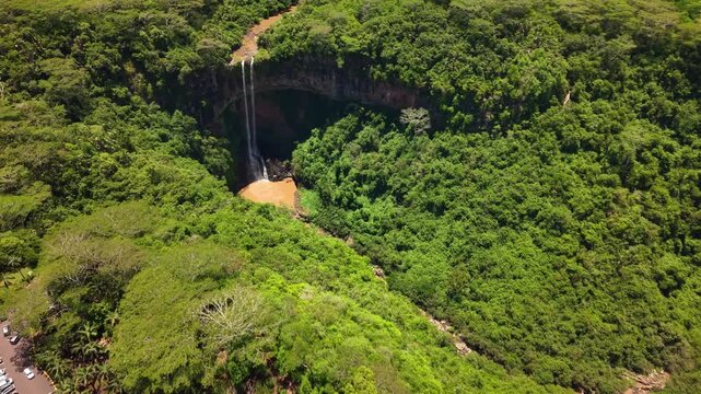 Aerial view of Chamarel waterfall in Mauritius surrounded by lush tropical forest