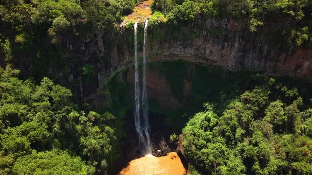 Aerial view of Chamarel waterfall in Mauritius surrounded by lush tropical forest