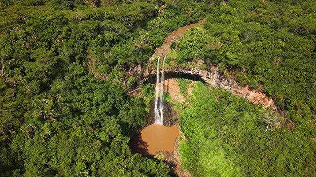 Aerial view of Chamarel waterfall in Mauritius surrounded by lush tropical forest