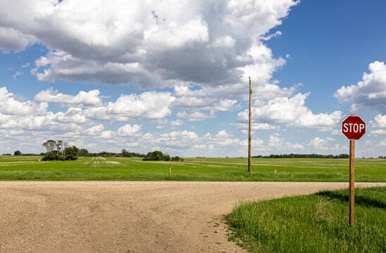 Stop sign on a gravel, grid road in rural Saskatchewan, Canada.