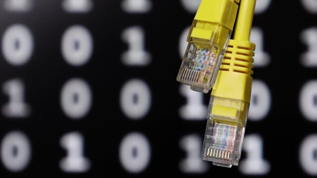 Two yellow Ethernet cable connectors are shown prominently against a blurred background featuring rows of binary code consisting of zeros and ones.