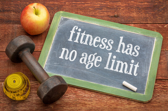 Fitness Has No Age Limit &ndash; motivational text in white chalk on a vintage slate blackboard with dumbbell, measuring tape, and apple, symbolizing lifelong fitness, health, strength, and active aging.