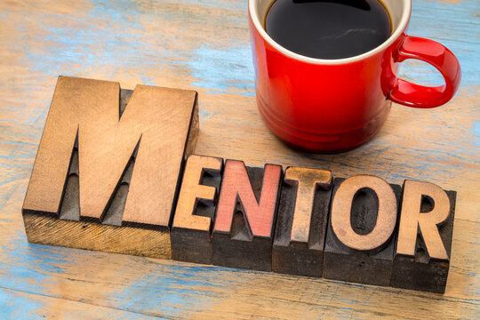 mentor word in vintage letterpress wood type printing blocks stained by color inks, role model and couching concept