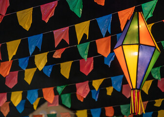 Fototapeta premium Traditional Brazilian Festa Junina Decoration with Colorful Paper Lanterns and Bunting Flags