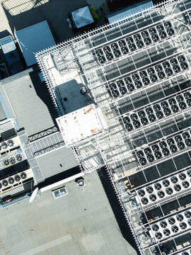 Aerial view of the EU North Riga LV DC1 data center rooftop featuring rows of industrial cooling units and ventilation systems in Riga, Latvia.