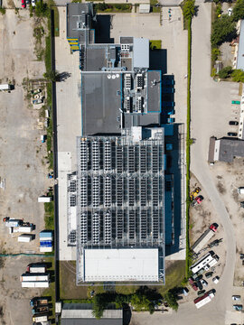 Aerial view of the EU North Riga LV DC1 data center featuring rows of cooling units on the roof and surrounding industrial grounds in Riga, Latvia.