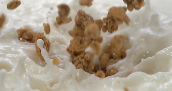 Granola falling into milk in super slow motion for breakfast cereal advertising