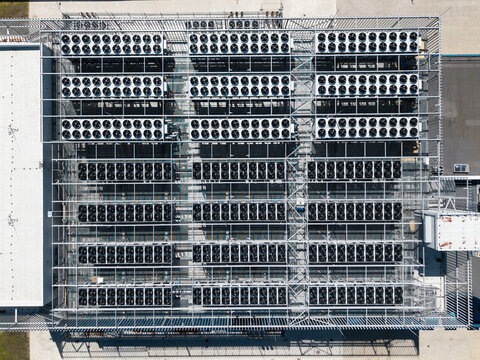 Aerial view of the EU North Riga LV DC1 data center cooling system featuring rows of industrial fans and metal infrastructure in Riga, Latvia.
