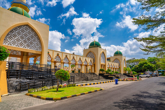 Exterior view Masjid Raya Hubbul Wathan largest mosque Lombok modern Islamic architecture colorful towers city skyline backdrop