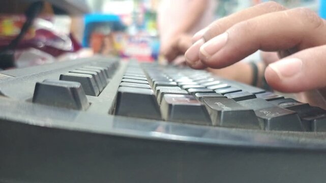 Close-up of human hands fast typing on a black computer keyboard, data entry and office work concept